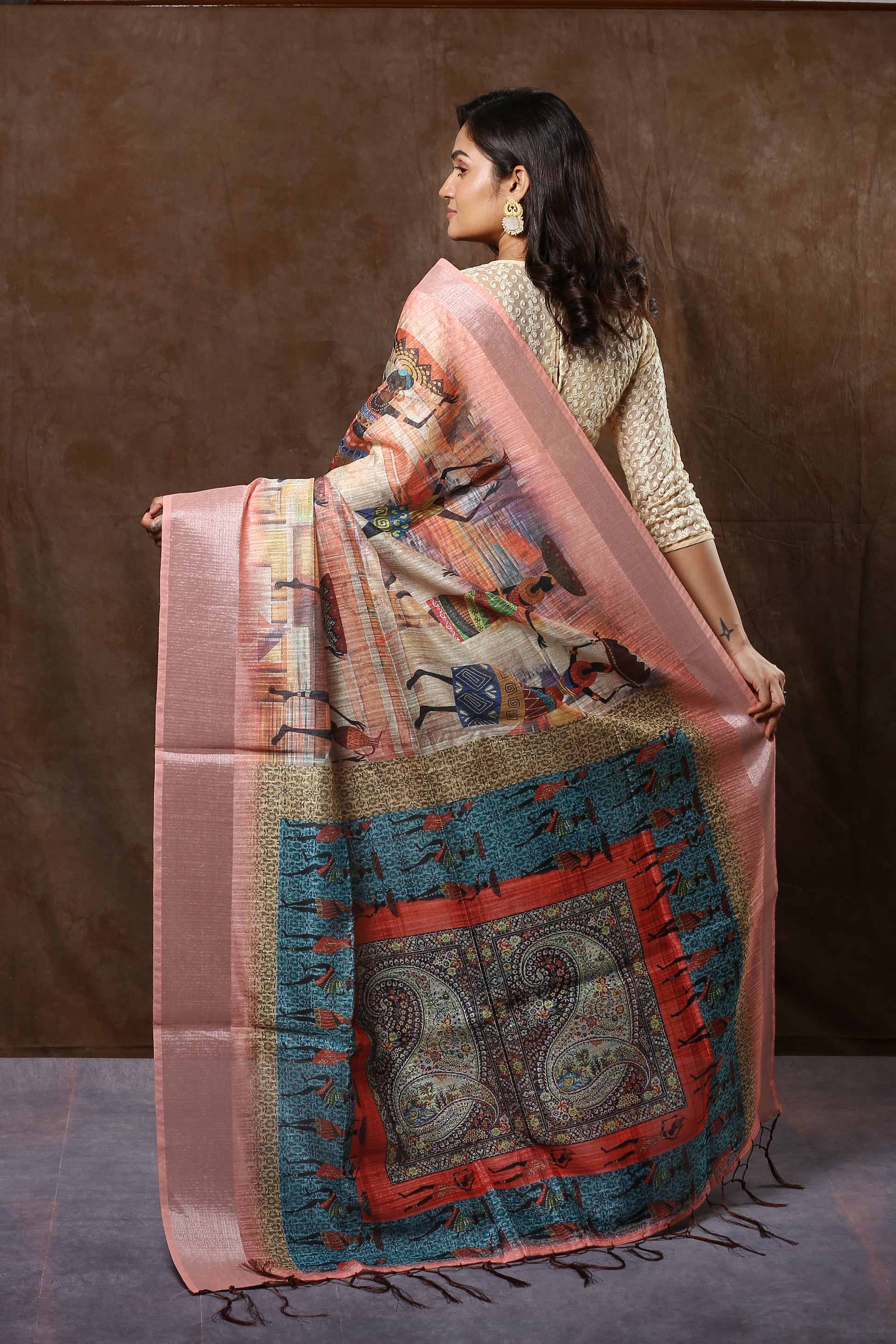 Cream raw silk saree with ancient wall painting figures and Kolka pallu, perfect for weddings | Urbane Essence