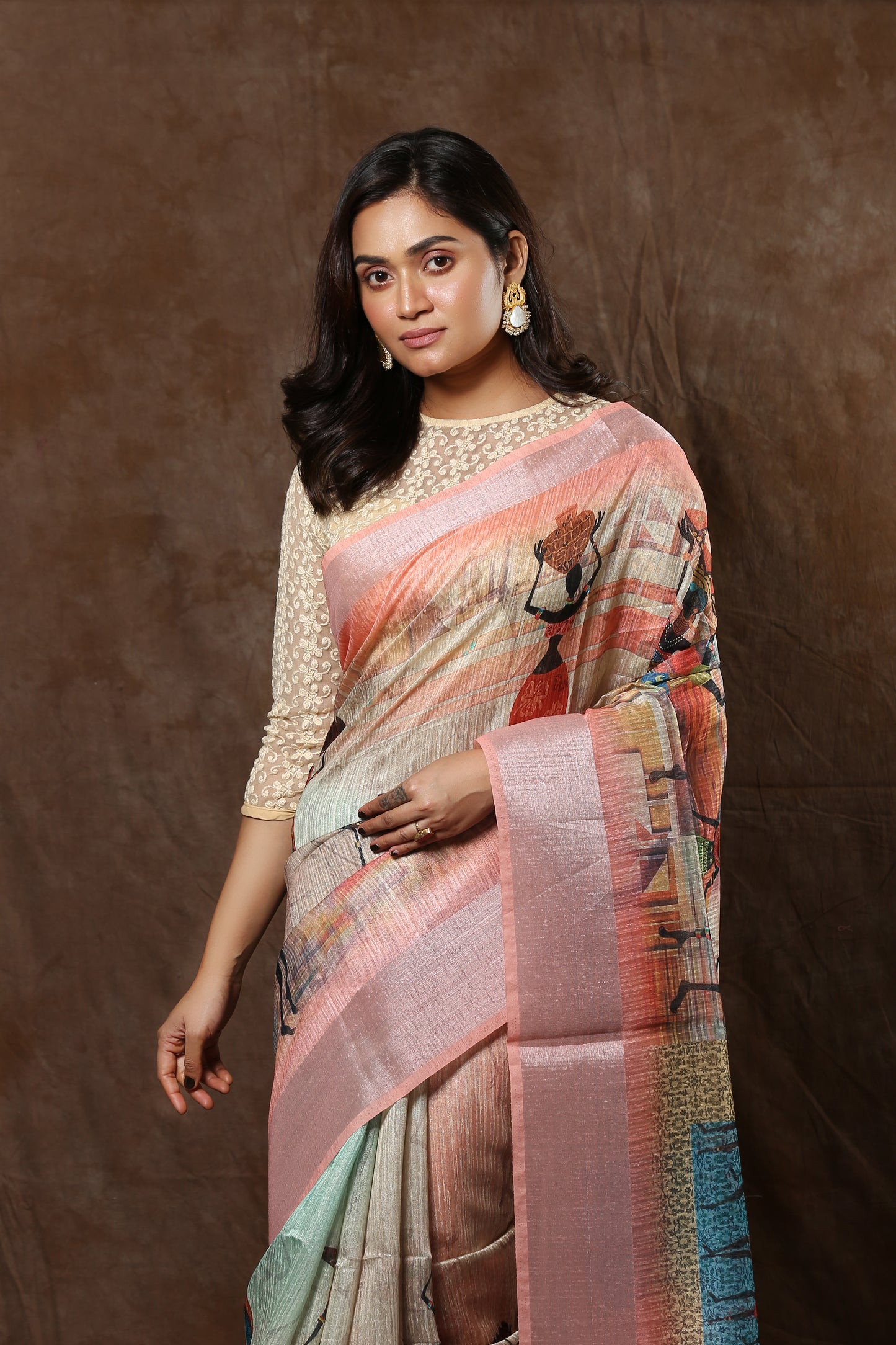 Cream raw silk saree with ancient wall painting human figures and Kolka pallu, perfect for weddings | Urbane Essence