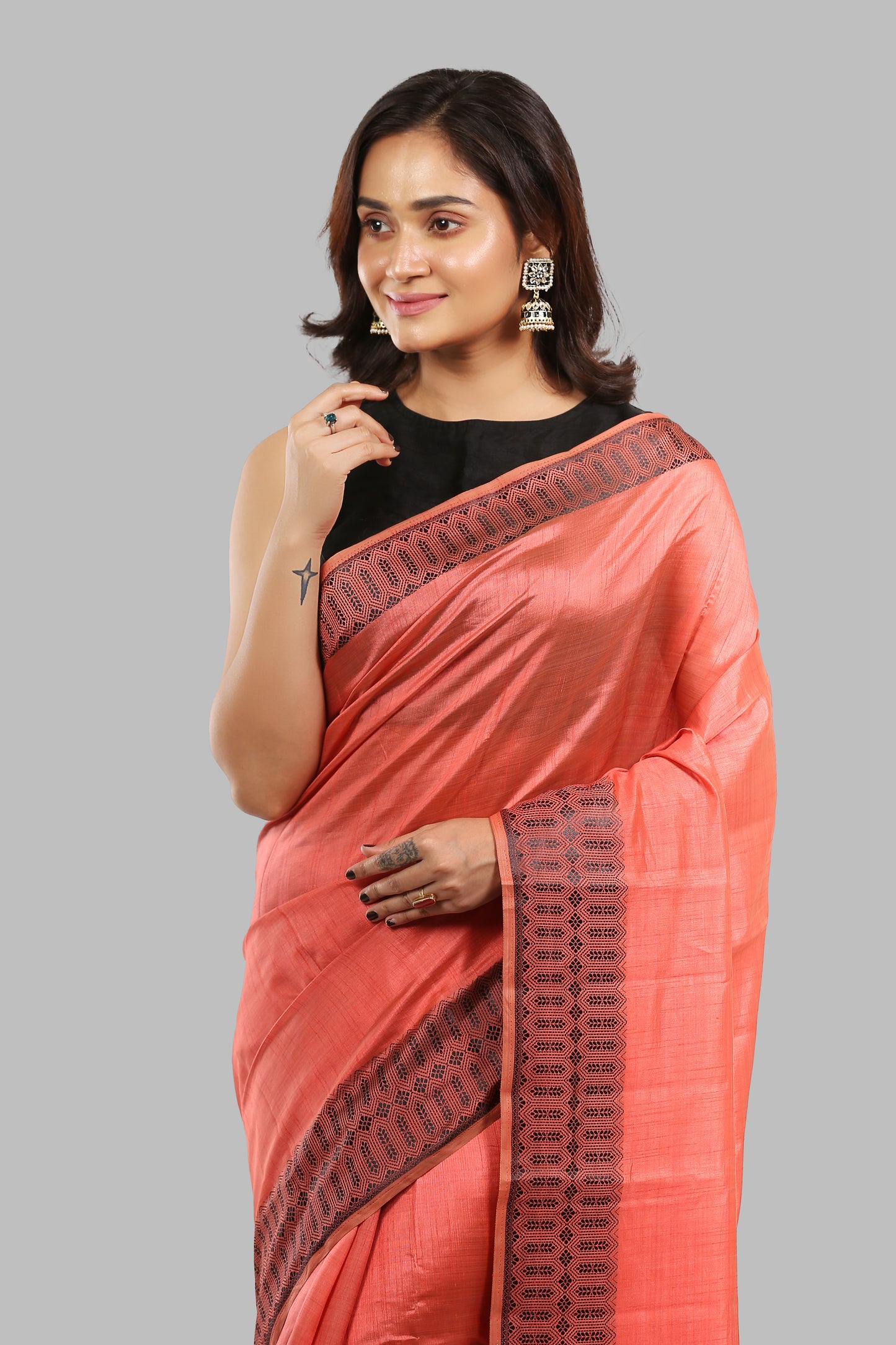 Sun-kissed rosewood raw silk saree with broad green border, golden zari patterns, traditional occasion wear | Urbane Essence