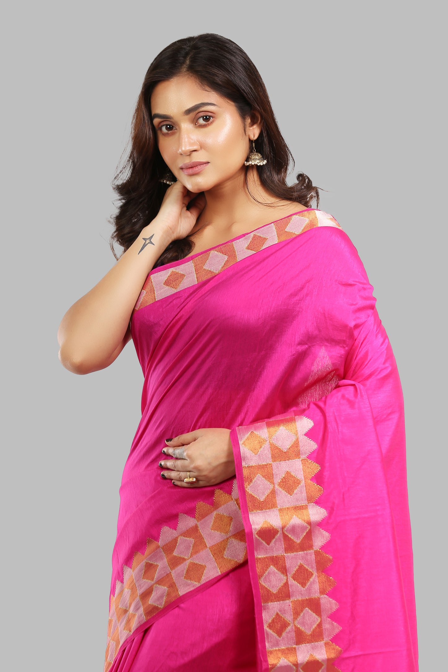 Sun-kissed Rosewood raw silk saree with broad green border, golden zari patterns, traditional occasion wear | Urbane Essence