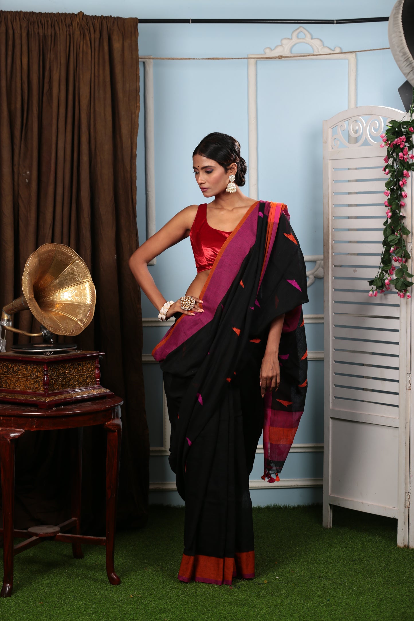 Assamese black Khadi saree with vibrant pink and orange geometric patterns, perfect for festive wear. | Urbane Essence