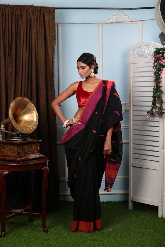 Assamese black Khadi saree with vibrant pink and orange geometric patterns, perfect for festive wear. | Urbane Essence