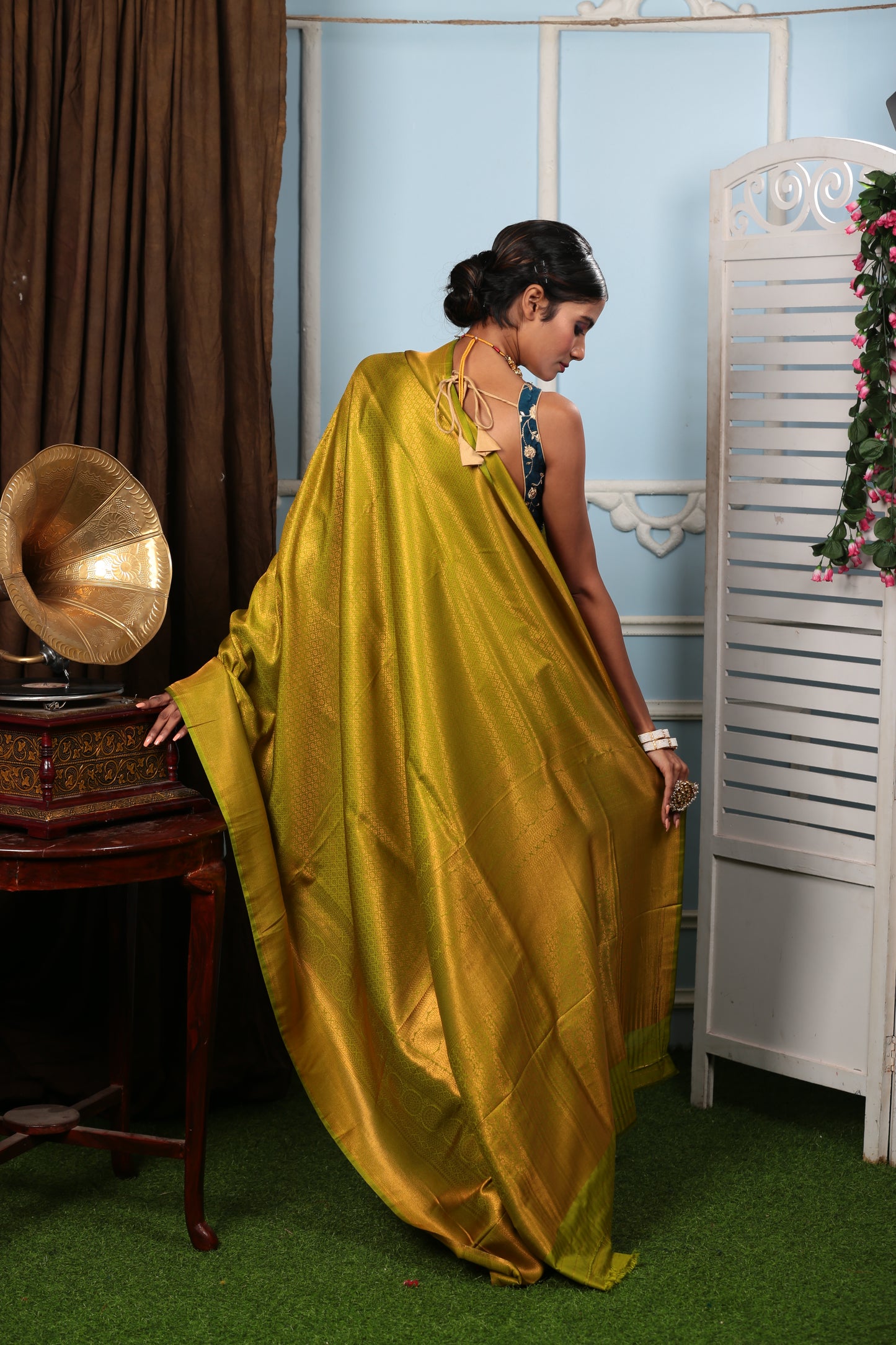 Woman in a lustrous copper-green South silk saree, perfect for weddings and celebrations | Urbane Essence