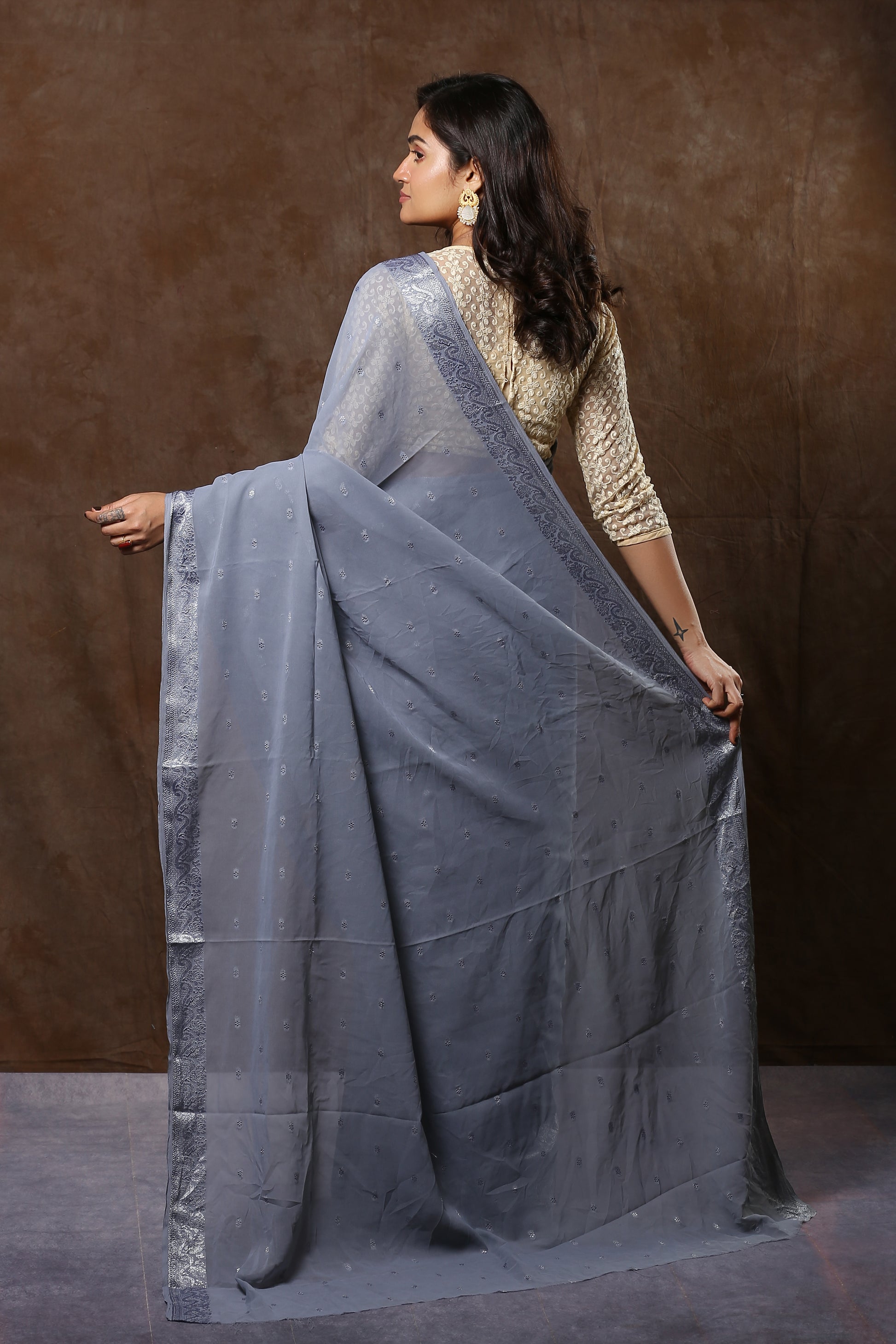 Uplifting porpoise georgette saree with silver zari border and spaced booty, perfect for classy evenings | Urbane Essence