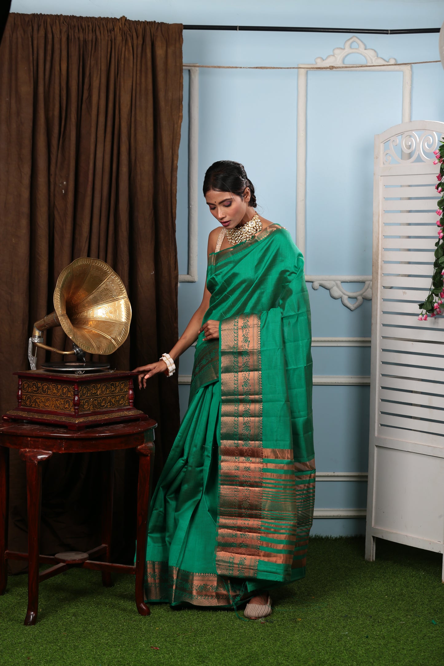 Munsell green raw silk saree with golden copper border, ideal for celebratory occasions | Urbane Essence