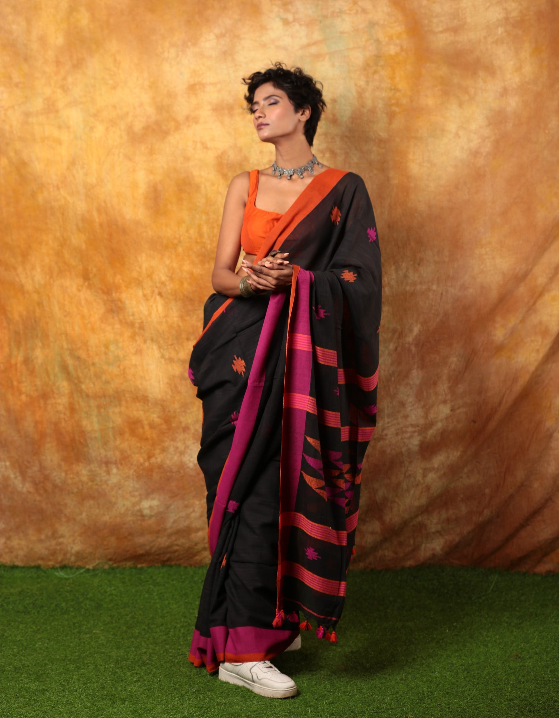 Black Assam Khadi saree with pink and orange twilight border, perfect for festive occasions. | Urbane Essence